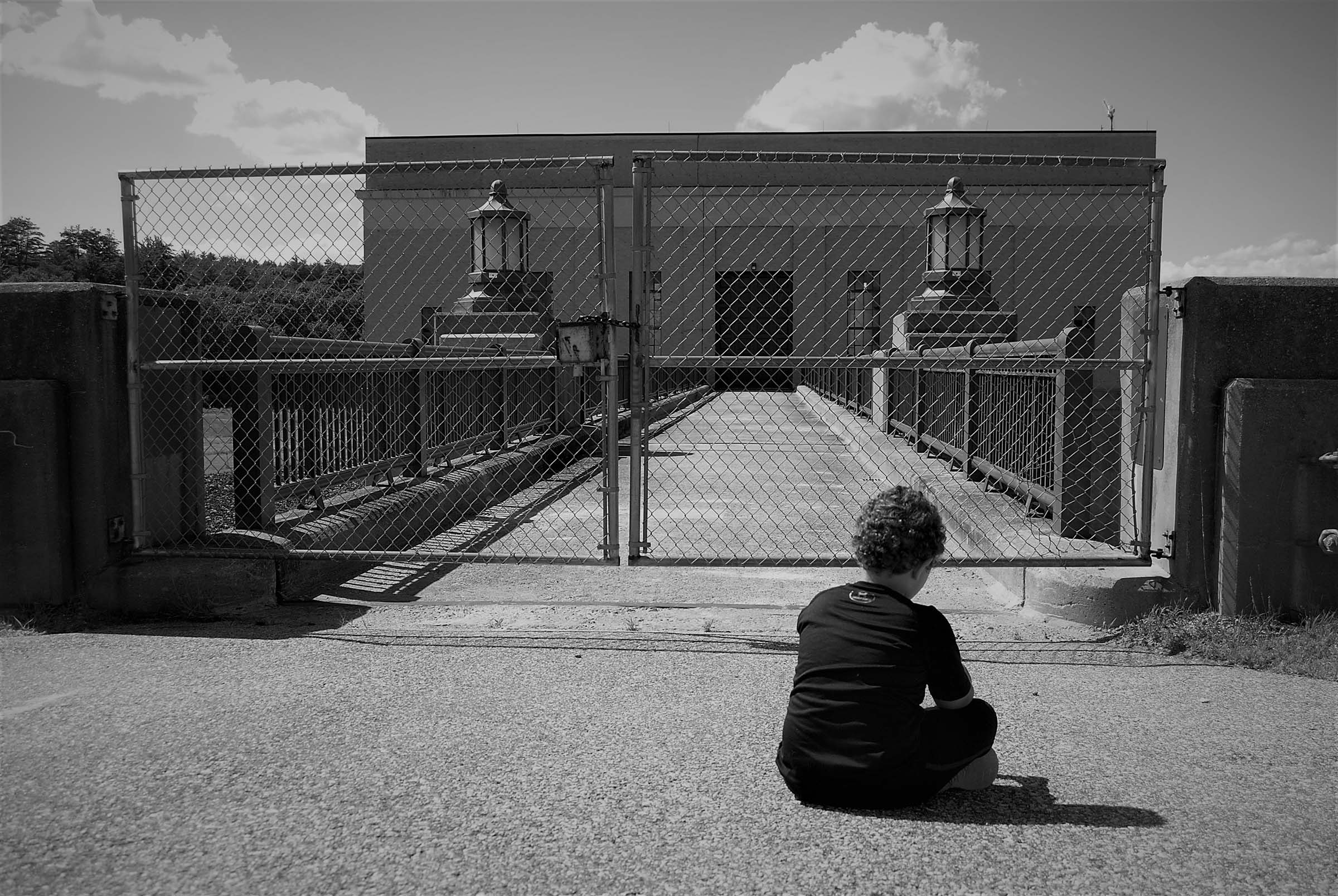 boy sitting at dam